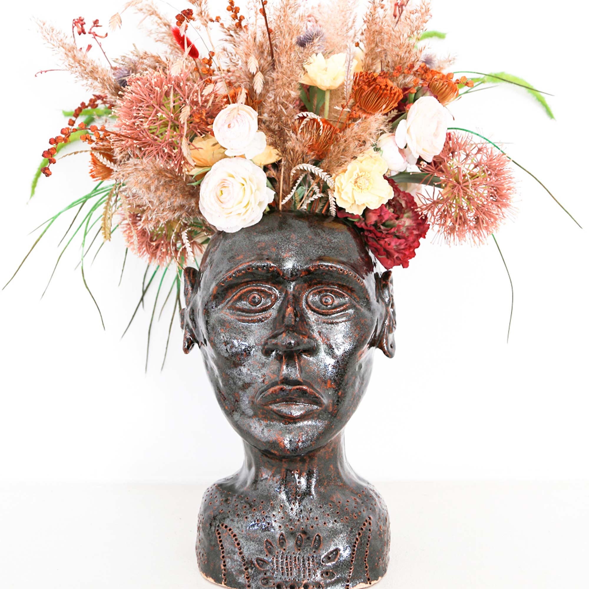 Unique brown face sculpture with flowers for home decor