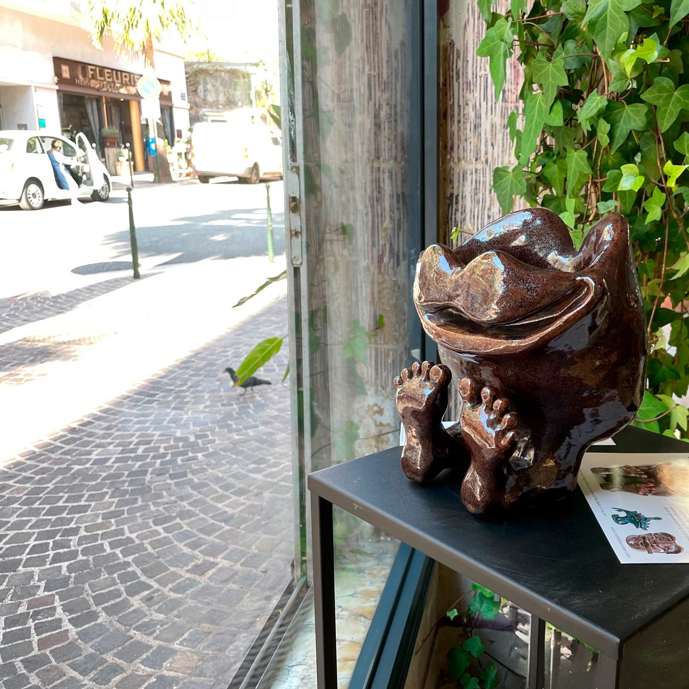 Unique brown happy feet and face sculpture for home decor at a gallery in France